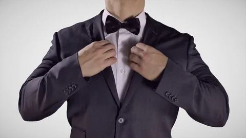 4K Man Fixing Bow Tie, Hands on Black Bow Tie, Elegant Black Tuxedo Suit Stock Footage 72334113