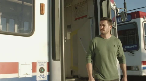 4K Man gets off of train and walks away Stock Footage 45300773