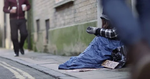 4k, Man hands over a hot drink to a homeless woman. Stock Footage
