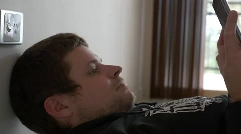 4k Man Laying Down Using Tablet Stock Footage 40298923