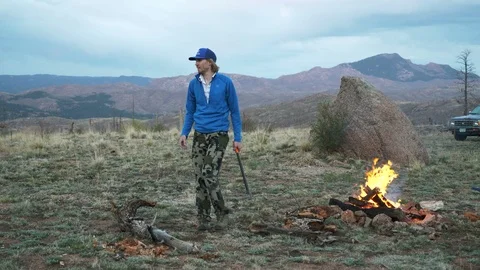 4K Man Pacing With Axe and Picking Up Firewood in Colorado Stock Footage 107634190