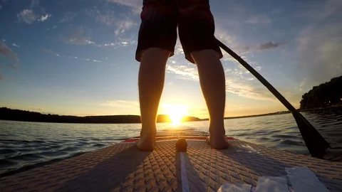 4K. Man paddling SUP at ocean sunset.Slomo Stock Footage 92361069