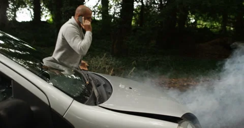 4k, A man phoning roadside assistance because his car has broken down Stock Footage 68362910