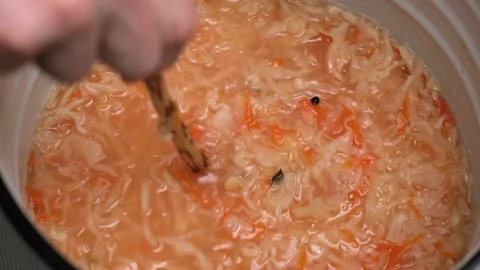4K A man pierces sauerkraut with a stick to release carbon dioxide. Close-up. Stock-Footage 167221753