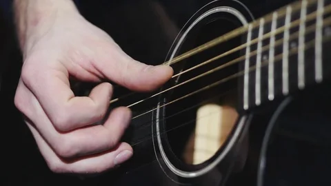 4k Man playing black classic guitar fingers Stock Footage 72820752