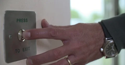 4k Man pressing exit button to leave work and exit building Stock Footage 96685882