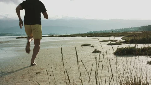 4K Man running on the beach Stock Footage 93073952