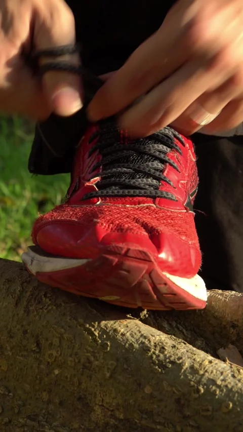 4K Man running jogger tying shoelace on tree of Park City. Healthy lifestyle Stock Footage 314818607