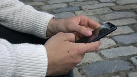 4K. Man sending SMS or email with his smartphone. Hands typing on phone-Adrian Stock Footage 95726940