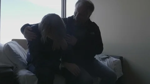 4K Man Sitting on Bed Being Consoled Near Window Slowmotion Stock Footage 100799877