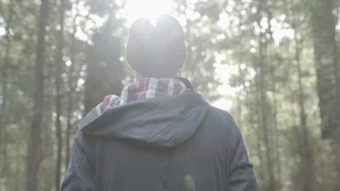 4K FOR man stnading in forest sun walks into forest LOG UNGRADED ProRes Stock Footage 101764246