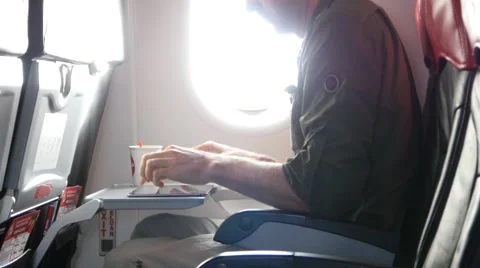 4k man tablet pc ipad airplane plane writing typing reading working business Stock Footage 64043803