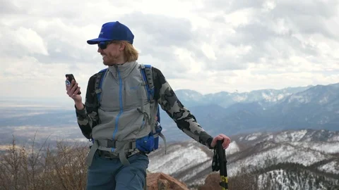 4K- Man Talking On Cellphone on Mountain Summit and Smiling Video stock 105354073