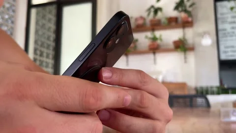 4k. Man using iPhone 12 smartphone pressing finger, reading social media Stock-Footage 201874259