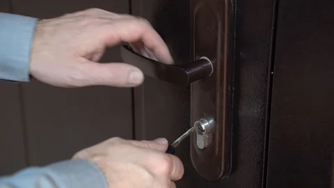 4K . man using a key, opens / closes the lock . Stock Footage 129326335