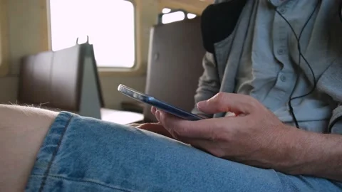 4K A man using a mobile phone on public transport, male hands and phone close-up Stock Footage 159526282
