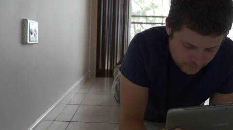 4k Man Using Tablet on Floor 库存影片 40320090