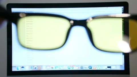 4K man using yellow lens editing glasses on computer for work Stock Footage 88503189