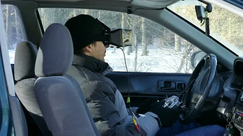 4K. Man in virtual glasses screen operates drone  for Radio transmitter System. Stockbeeldmateriaal 72185089