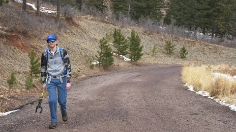4K - Man Walking Up Hill Deer With In Background Video stock 105328831