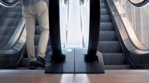 4K. Man walking up on modern escalator stairs Stock-Footage 91007146
