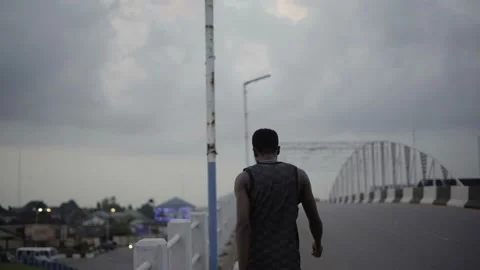 4k man walking over bridge at dusk blue hour Stock Footage 238691867