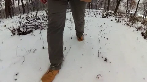 4K. Man walking on snow. Stock Footage 70378220