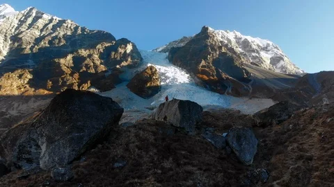 4k man walks on rock in front of big ice fall in Langtang Valley in Nepal Stock Footage 107662602