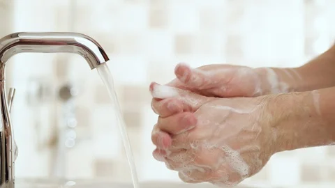 4K - Man washes hands. Side view Video stock 128547237