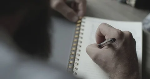 4k Man Writes in Notebook Vídeo Stock 104971866