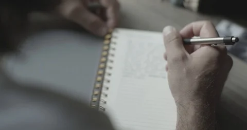 4k Man Writing in Notebook Vídeo Stock 104971841