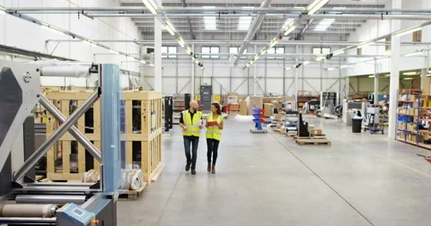 4K Management team having a discussion in factory warehouse Stock Footage 68926601