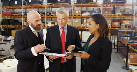 4K Management team in warehouse checking inventory &amp; looking over the figures Stock Footage 68932882