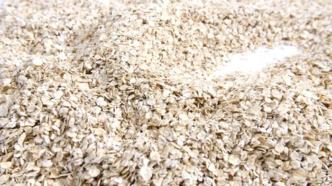 4K mans chef hands scooping cup of Dry oats falling onto oatmeal pile of cereal Stock Footage 88532200