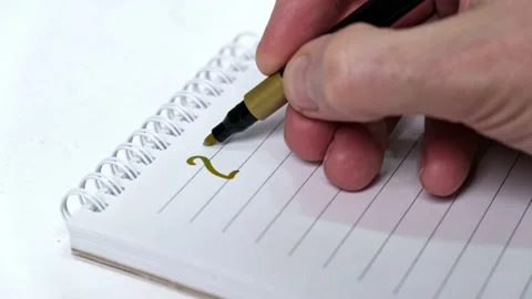 4K A man's hand writes the numbers of 2022 with a gold felt-tip pen in notebook. Stock Footage 166504016