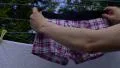 4K Man's hands hang pink boxer shorts laundry on washing line in garden 4k or 4k+ Resolution