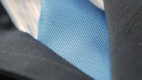 4k of man's suit jacket close up to tie. Cam moves to the left Video stock 77444102