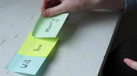4k Marriage proposal in multicolour post it notes on white table Stock Footage 61243726