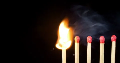 4K - Matchsticks on fire in row. Burning of matches sequence against BG Stock Footage 301341969