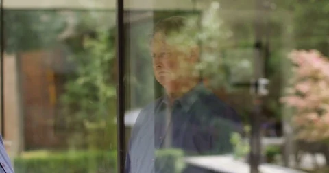 4K Mature man deep in thought, staring out of hospital window waiting for news Stock Footage 81187215