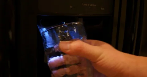 4K Medium close shot getting ice and water from refrigerator Stock Footage 100095098