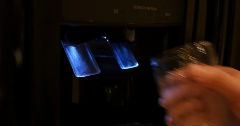 4K Medium close shot getting water from refrigerator Stock Footage 100095233
