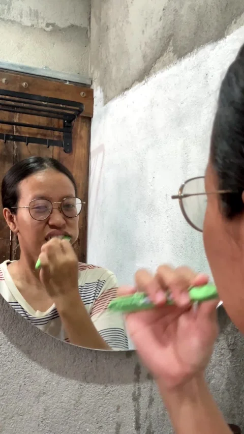 4K Medium Close Up of Young Woman Applying Face Sunscreen in a Room with Green C Vídeo Stock 337720412