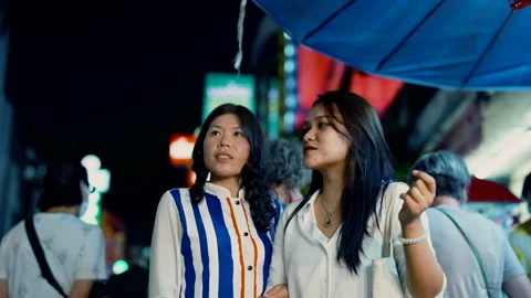 4K Medium shot, 2 long-haired Asian women who are best friends stand looking Stock Footage 205083189