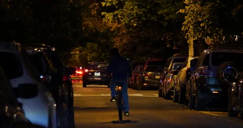 4K MEDIUM SHOT OF CYCLIST ON STREET AT NIGHT Stock Footage 131129502