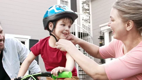 4k medium shot of father and mother teaching their son the importance of putting Stock Footage 201096970