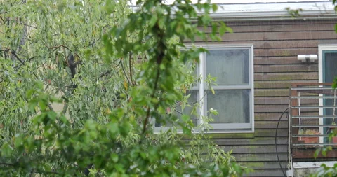4K MEDIUM SHOT OF HOUSE WINDOW IN THE RAIN Stock Footage 131128012
