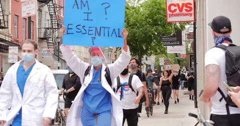 4K MEDIUM SHOT PROTESTERS WALKING DOWN CITY STREET Video stock 132598818