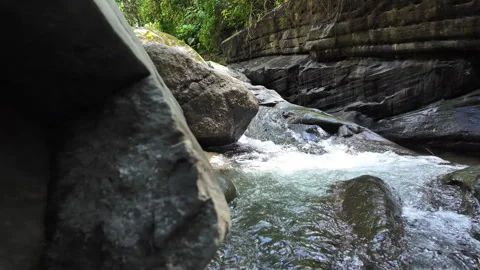4K Medium Shot Tracking Right Water Flowing Over Waterfall In Rainforest River Stock Footage 285872043