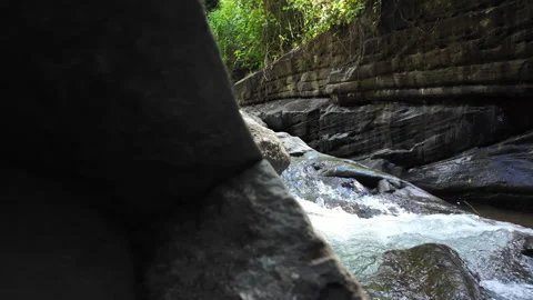 4K Medium Shot Tracking Right Water Flowing Over Waterfall In Rainforest River Stock Footage 285872080